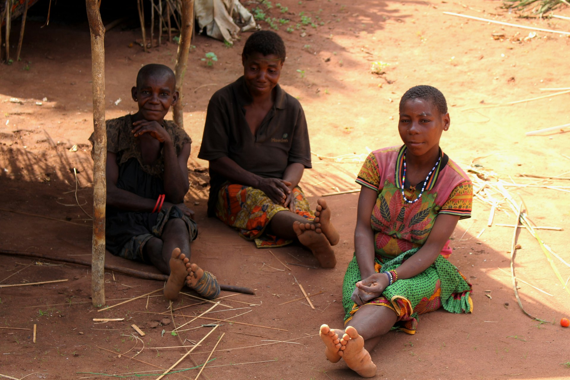 A group of people sitting on the ground